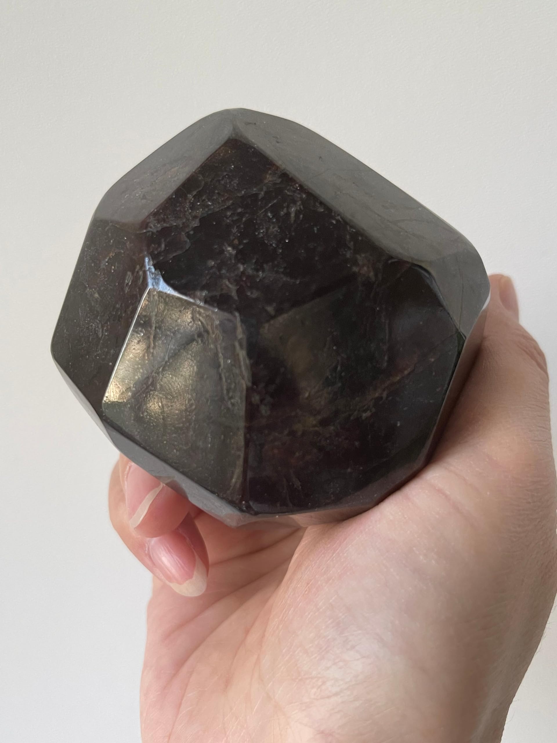 GAF TREASURES garnet polygon polished earth-toned hues on display