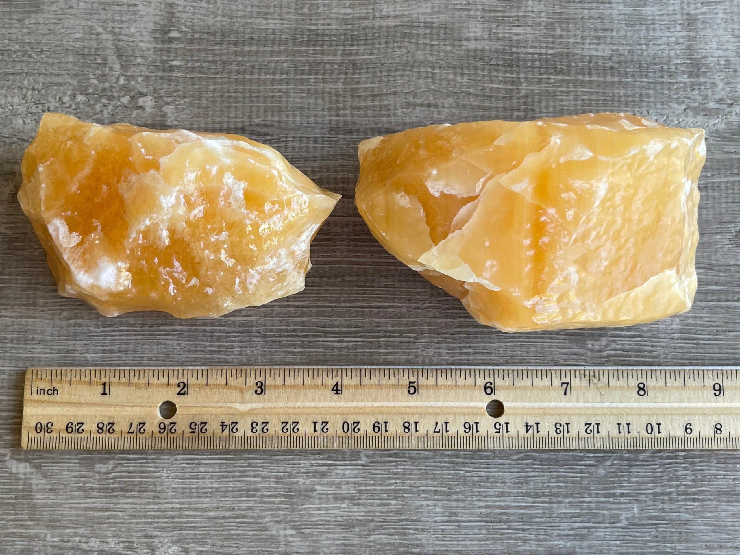 GAF TREASURES orange calcite rough stone shows natural hue differences.