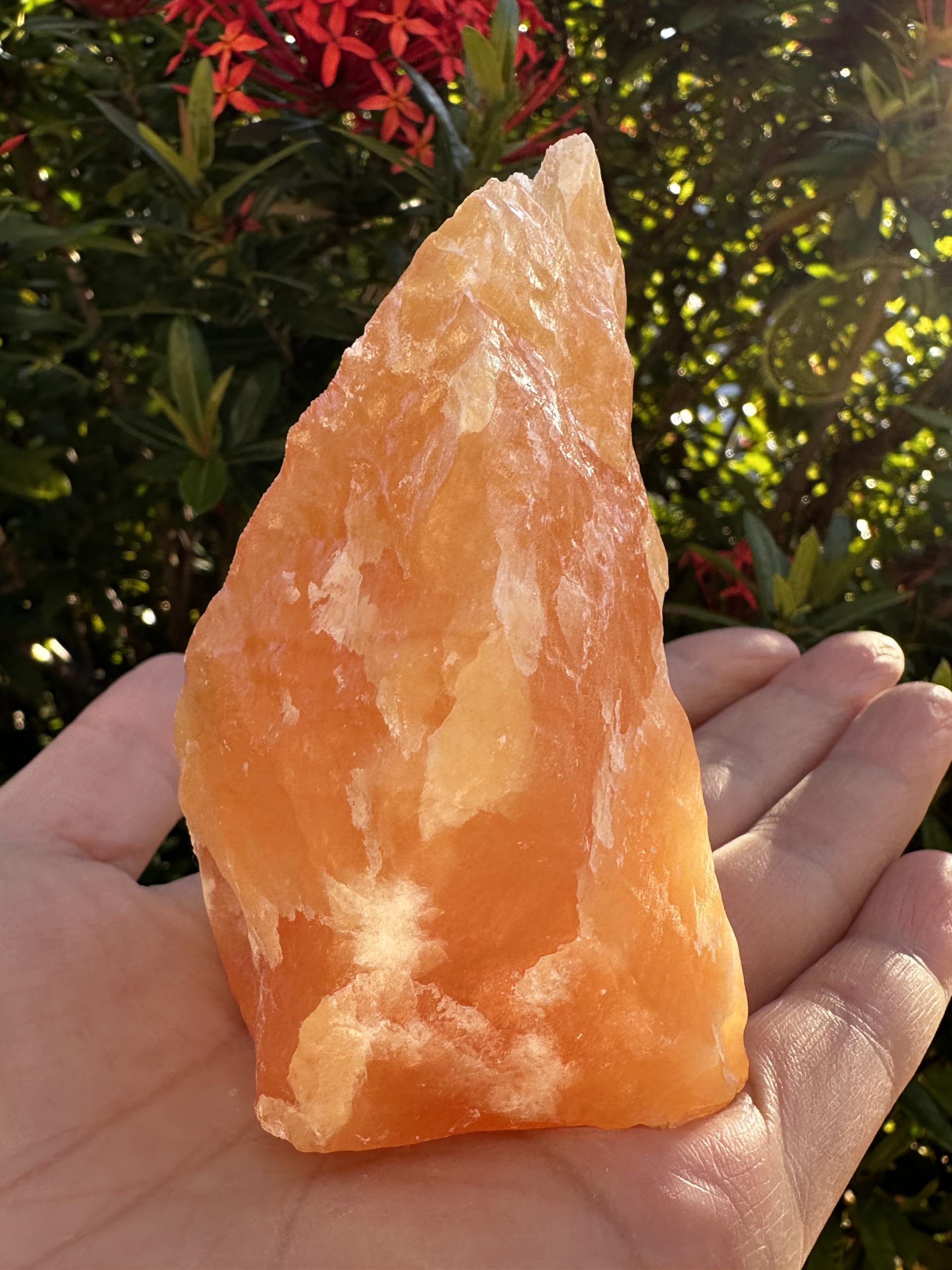GAF TREASURES orange calcite rough crystal close-up highlighting natural hue variations.