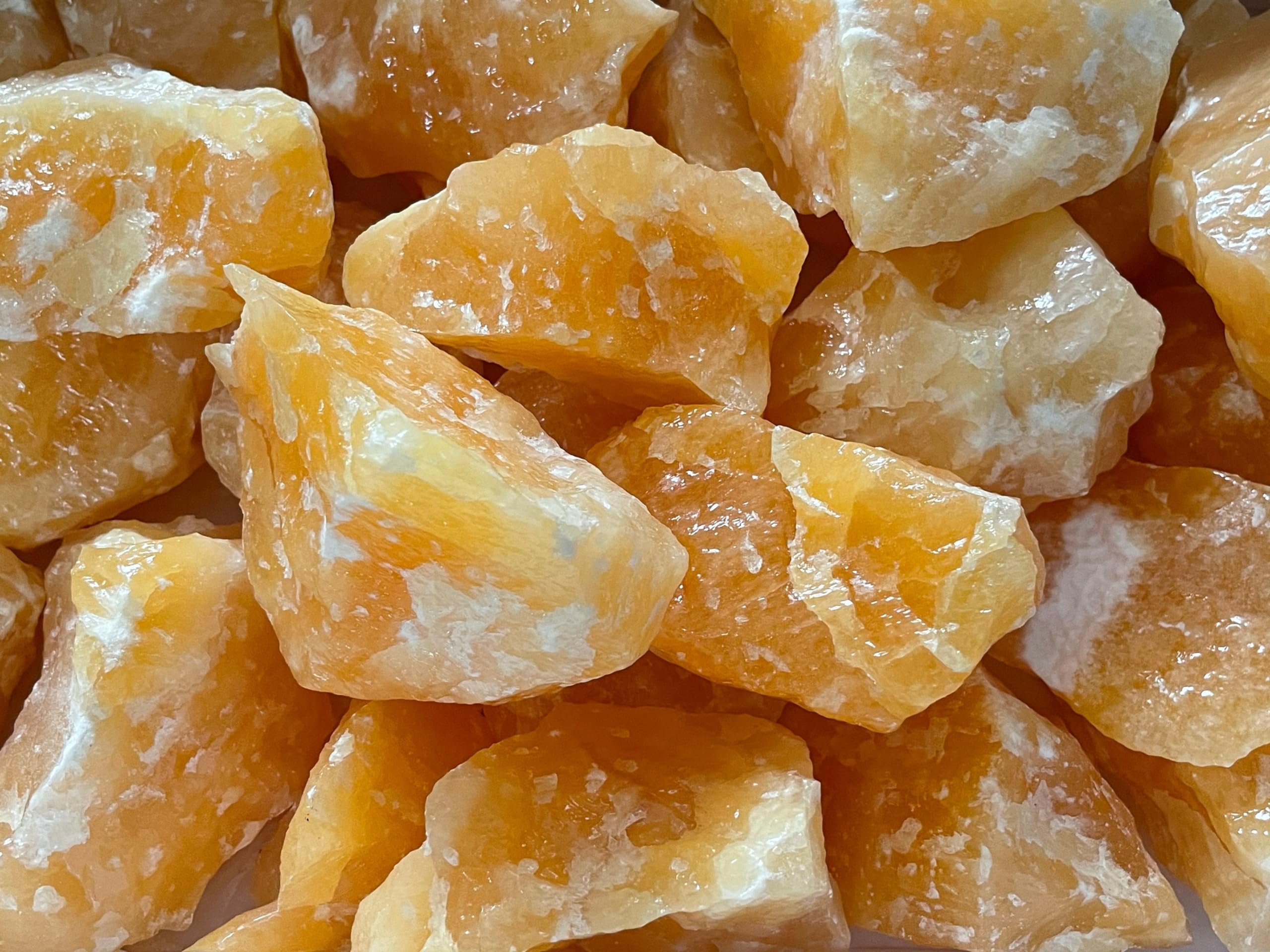 GAF TREASURES orange calcite rough stone from Mexico with natural size variations.