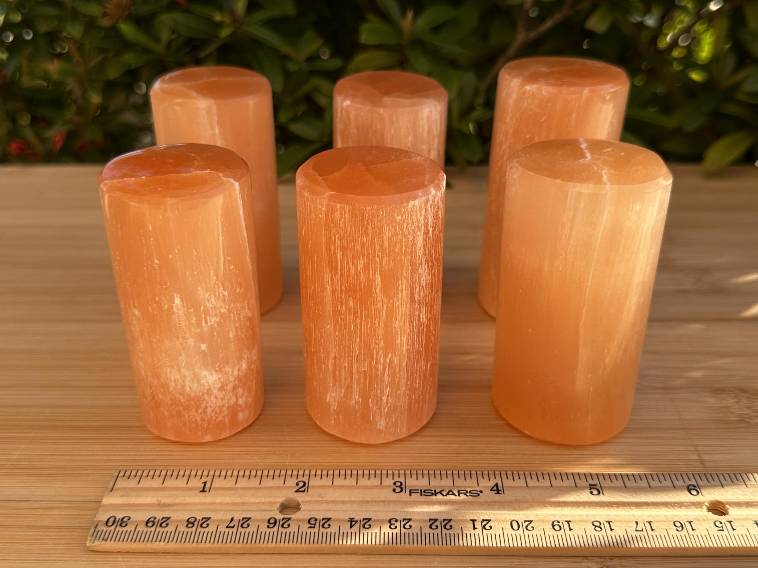 Ornament on an altar with orange selenite for intention setting and reflection.