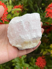 GAF Treasures pink calcite rough stone used in wire wrapping and decorative display.