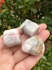 GAF Treasures Pink Opal polished rocks glow softly in light.