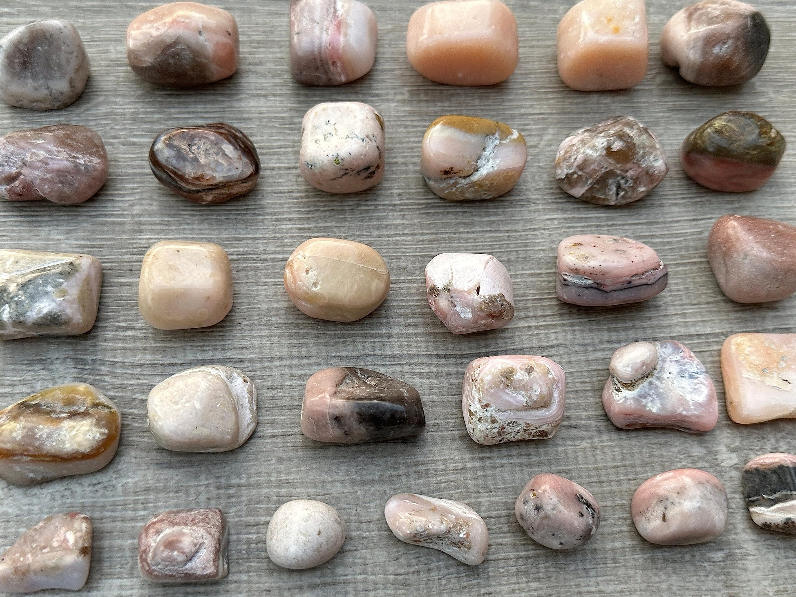 GAF Treasures Pink Opal tumbled stones held in hand during mindful breathing.