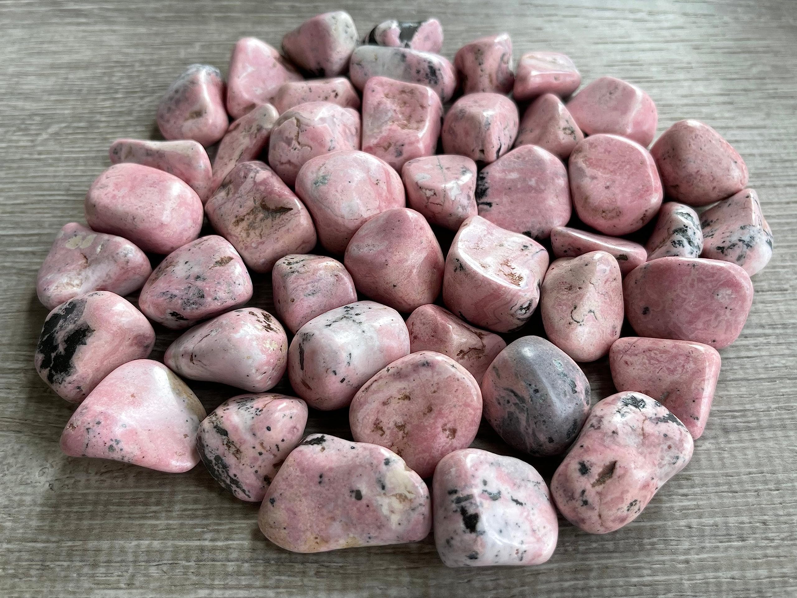 GAF TREASURES Rhodonite stones arranged in a crystal grid layout for therapies
