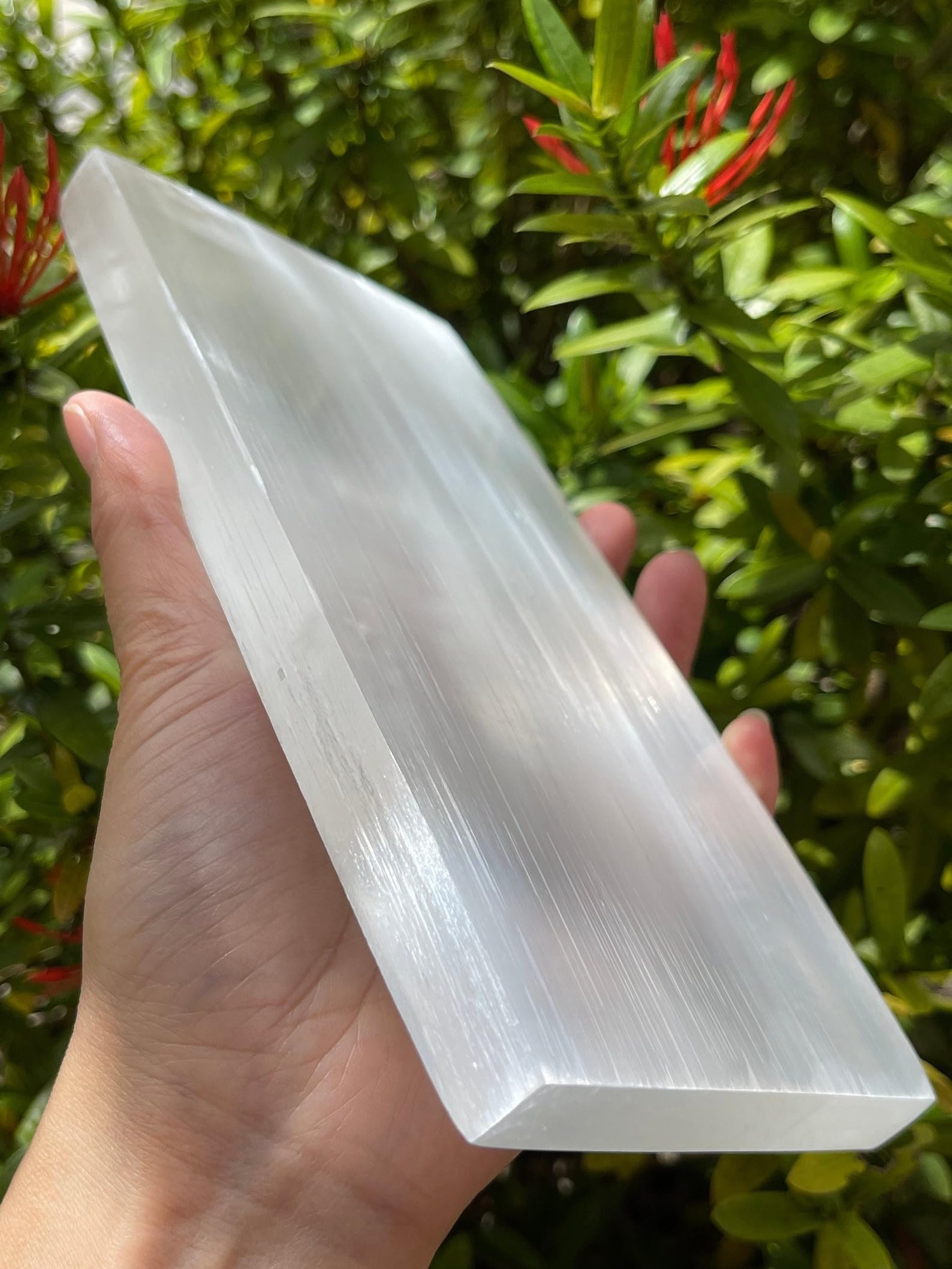GAF TREASURES selenite slab resting a jewelry set during cleansing