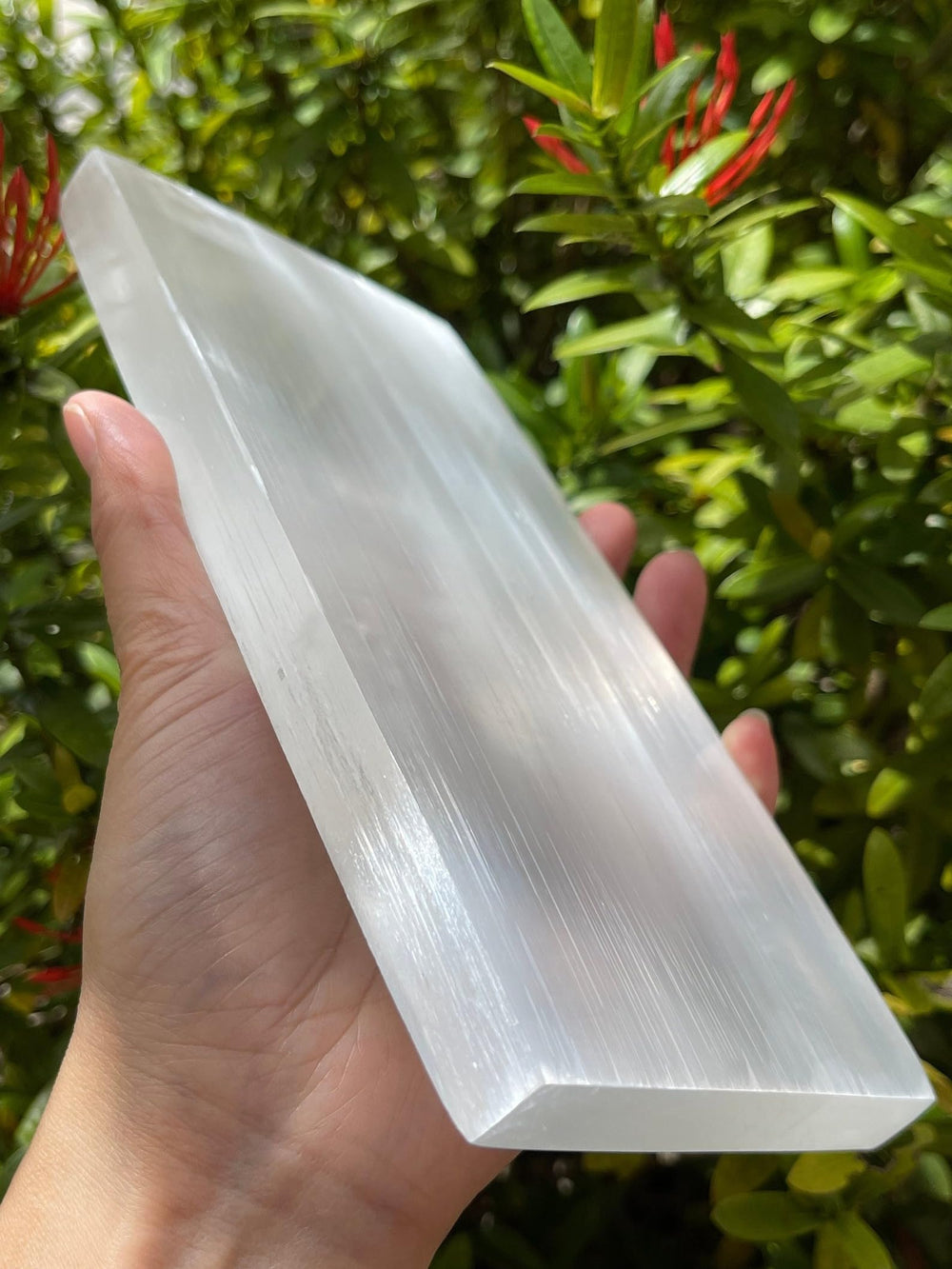 GAF TREASURES selenite slab resting a jewelry set during cleansing