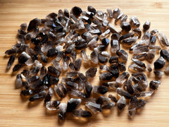 GAF TREASURES smoky quartz point rough enhances crystal grids with natural variations.