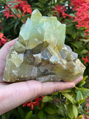 GAF TREASURES XL green calcite raw stone side angle highlights texture and color.