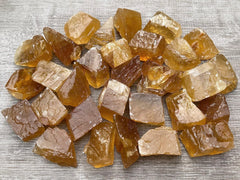 GAF TREASURES honey calcite rough pile highlights natural color variety for display