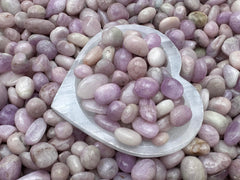 GAF TREASURES Kunzite polished stone close-up showing smooth finish and color variation.