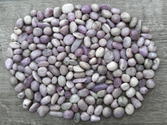 GAF TREASURES Kunzite tumbled stones in soft pink hues for calming meditation.