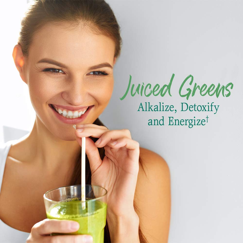 Pouring Garden of Life Super Greens into a glass for veggie boost
