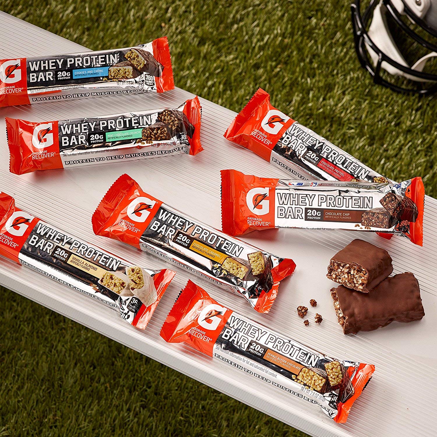 Glass of water beside Gatorade Whey Protein Recover Bar after training.