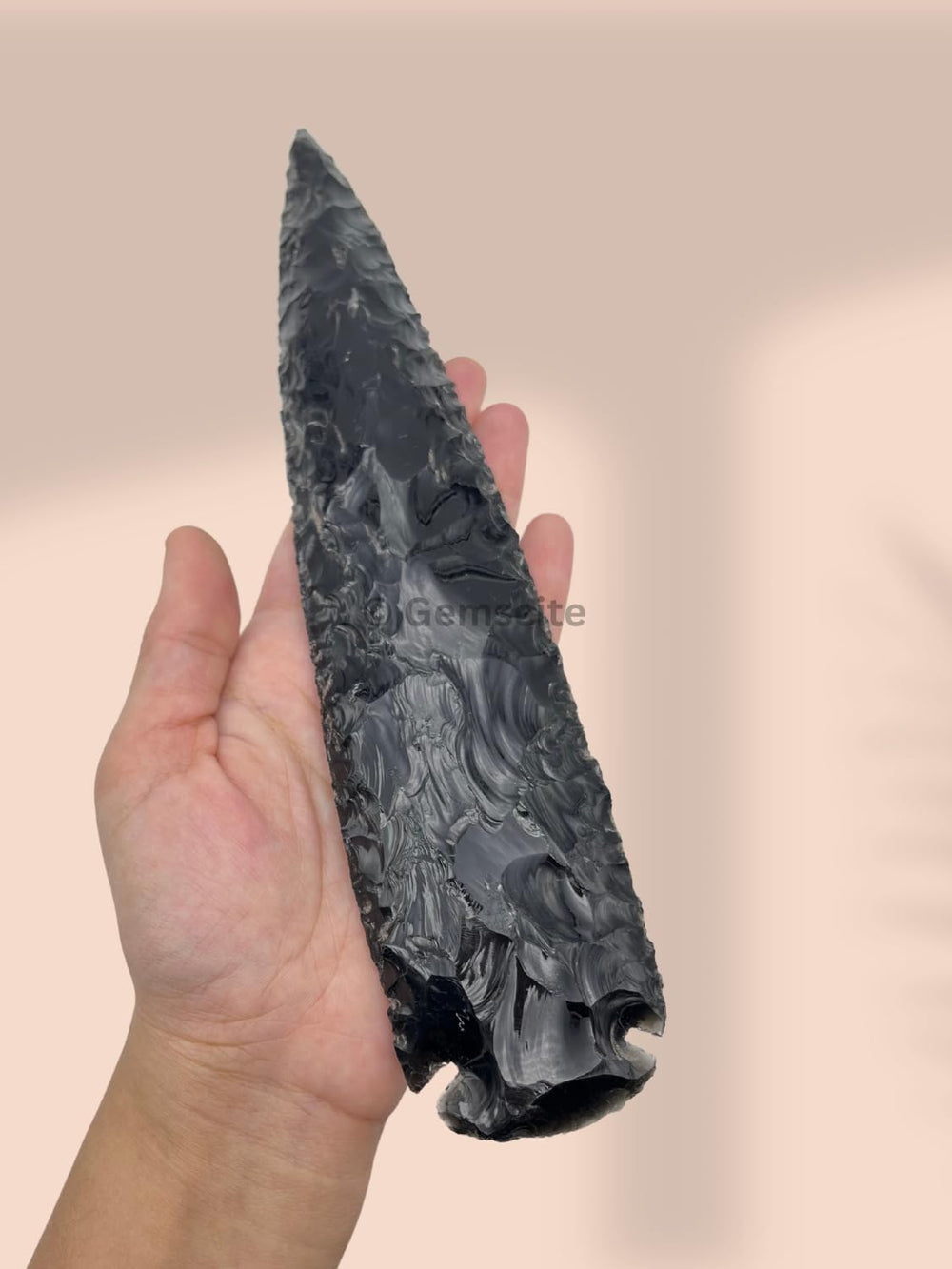 Raw GEMSCITE obsidian arrowhead highlighting natural stone color