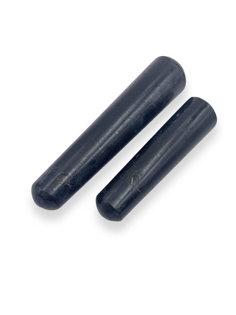 Close view shows natural variations in black tourmaline wand for energy work.
