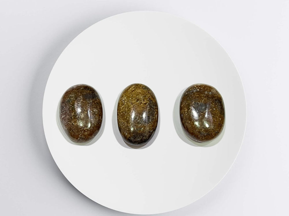 GEMSCITE Bronzite palm stone supporting chakra balancing during daily routines.