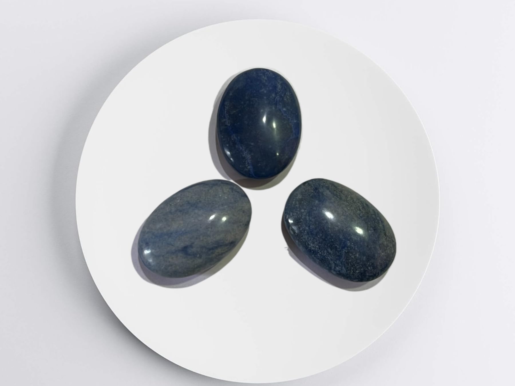 Gemscite Dumortierite palm stone on grid for chakra-inspired energy work