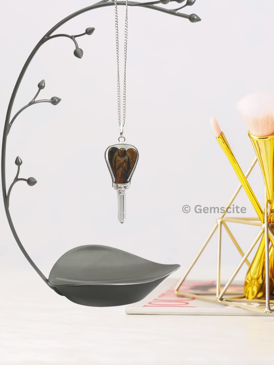 Close-up of GEMSCITE guardian angel pendant, tiger eye and quartz pairing