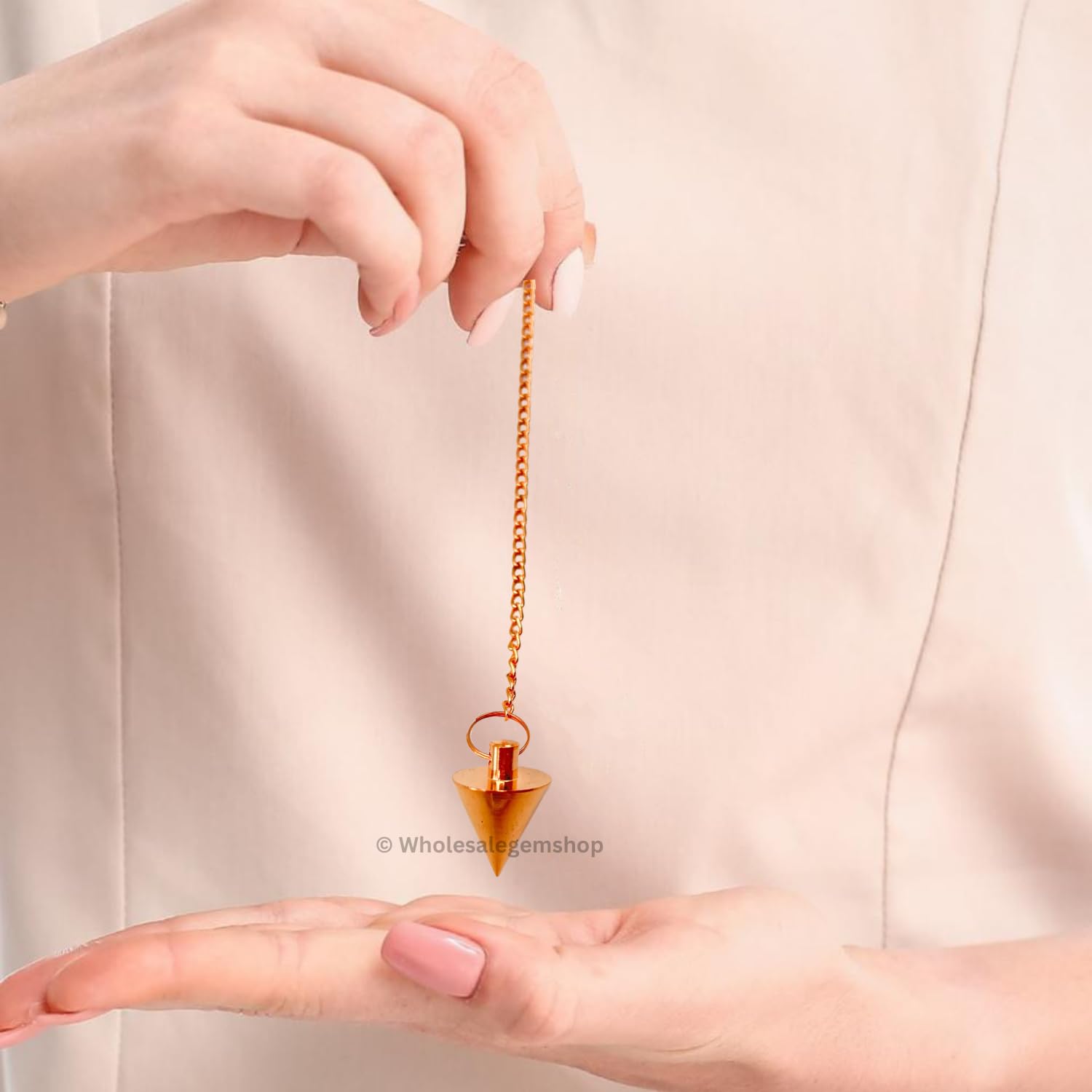 GEMSCITE pendulum in action for dowsing or focus exercises.