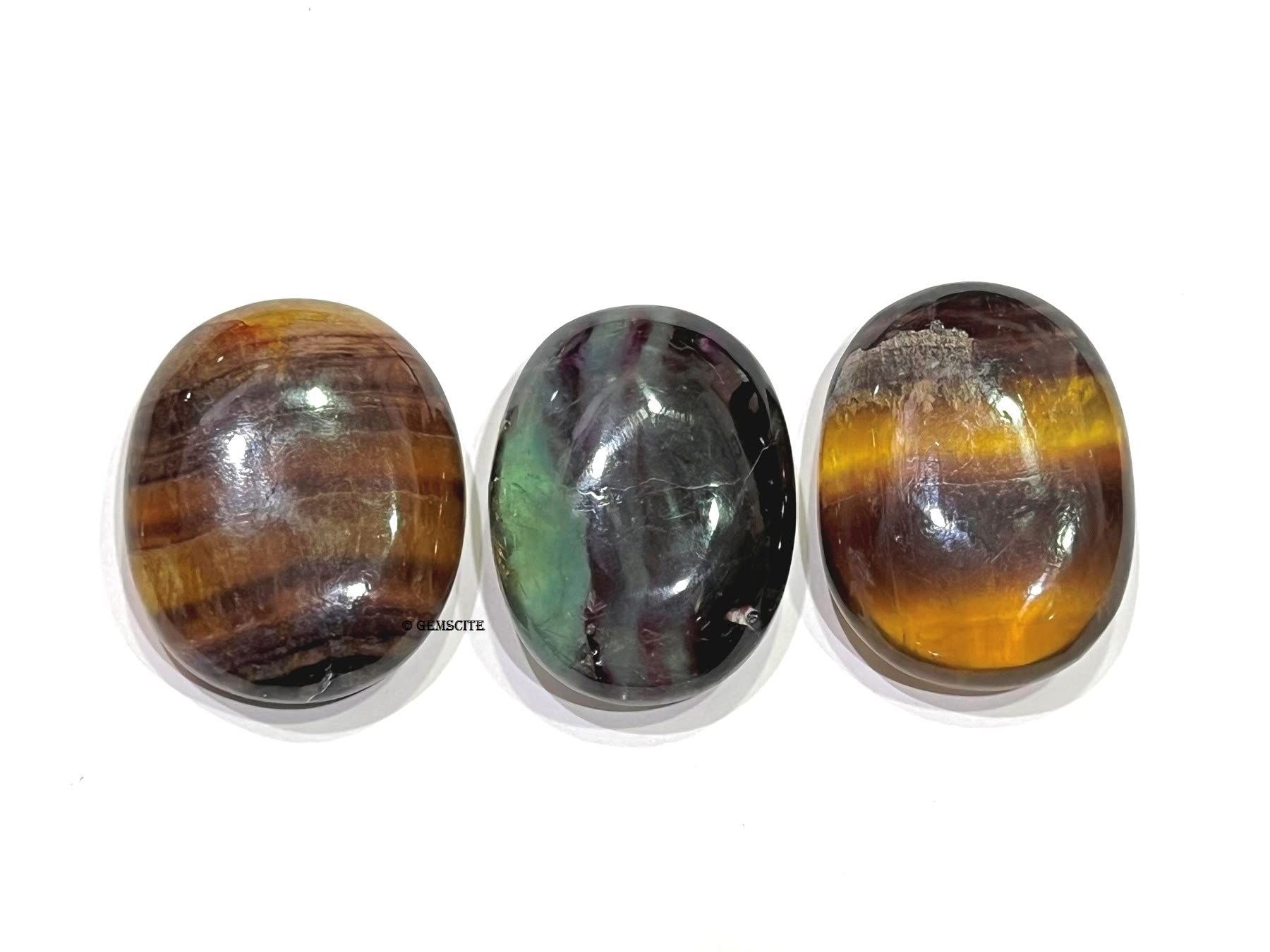 GEMSCITE Multi Fluorite palm stone in hand to aid focus and mindful breathing.