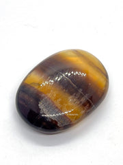 GEMSCITE Multi Fluorite palm stone in light highlights color variations for chakra alignment.