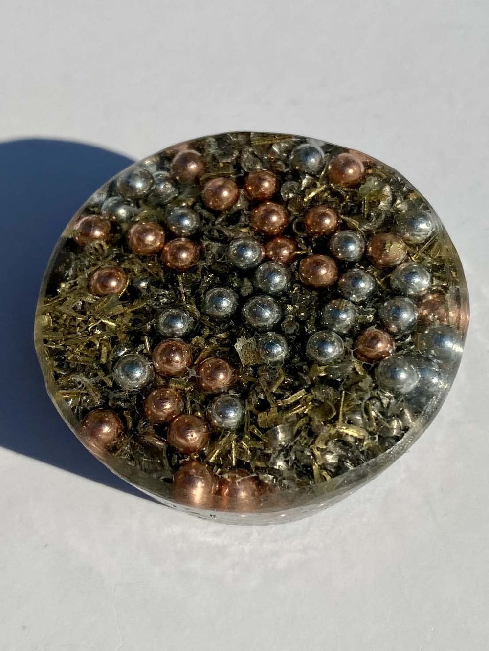 Generic blue-quartz tower-buster orgonite close-up showing layered ingredients for vitality