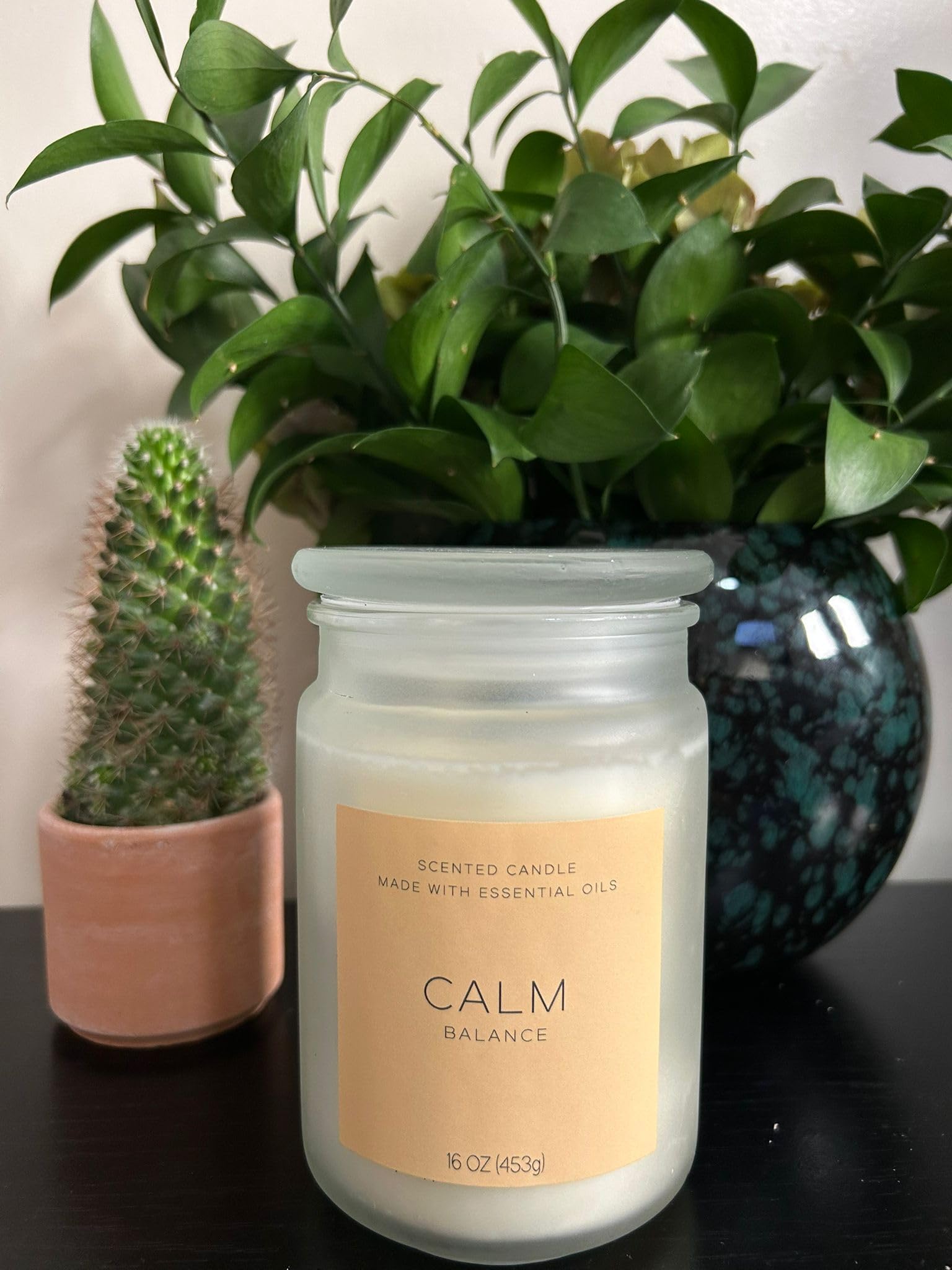 Generic Calm Balance candle jar close-up highlighting essential oil blend for aromatherapy