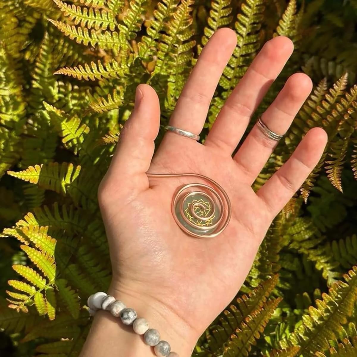 Generic copper palm spiral ring close-up with seven gems