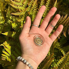 Generic copper palm spiral ring close-up with seven gems