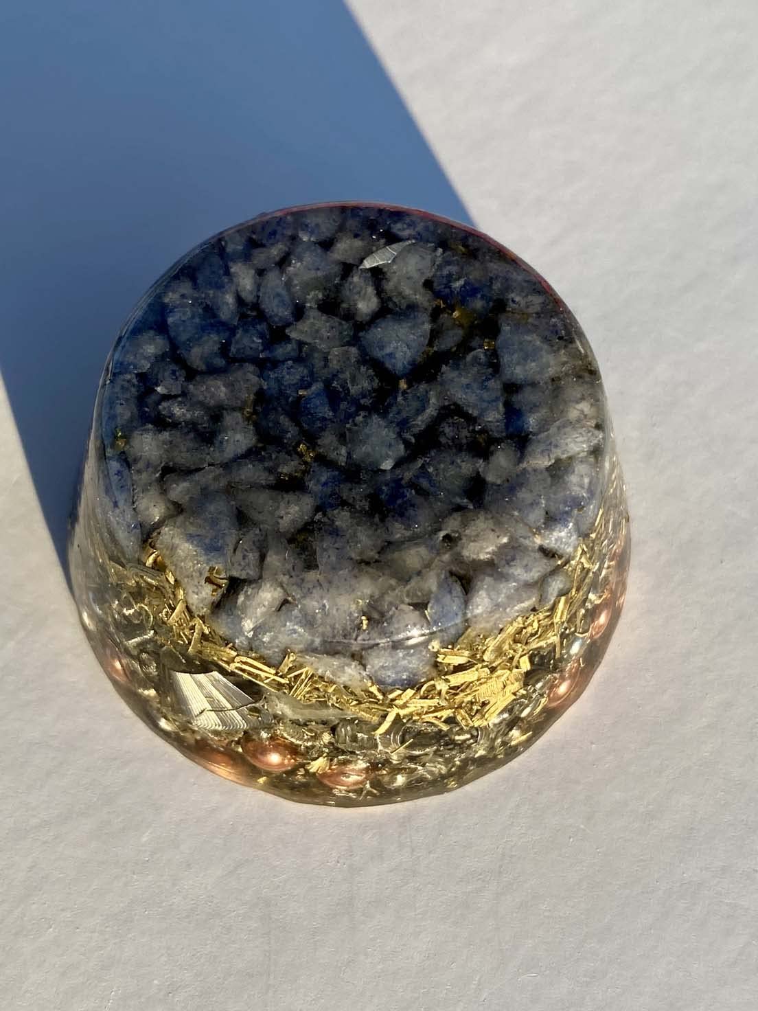 Generic holding blue quartz orgonite to imagine portable decor