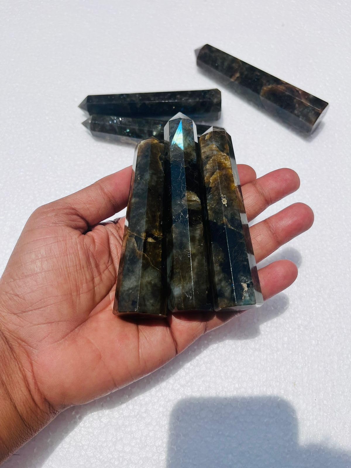 Generic Labradorite crystal point held in hand for meditation and clarity.