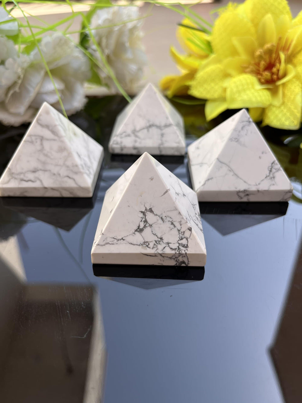 Generic size 50-55mm Howlite pyramid complements desk decor.