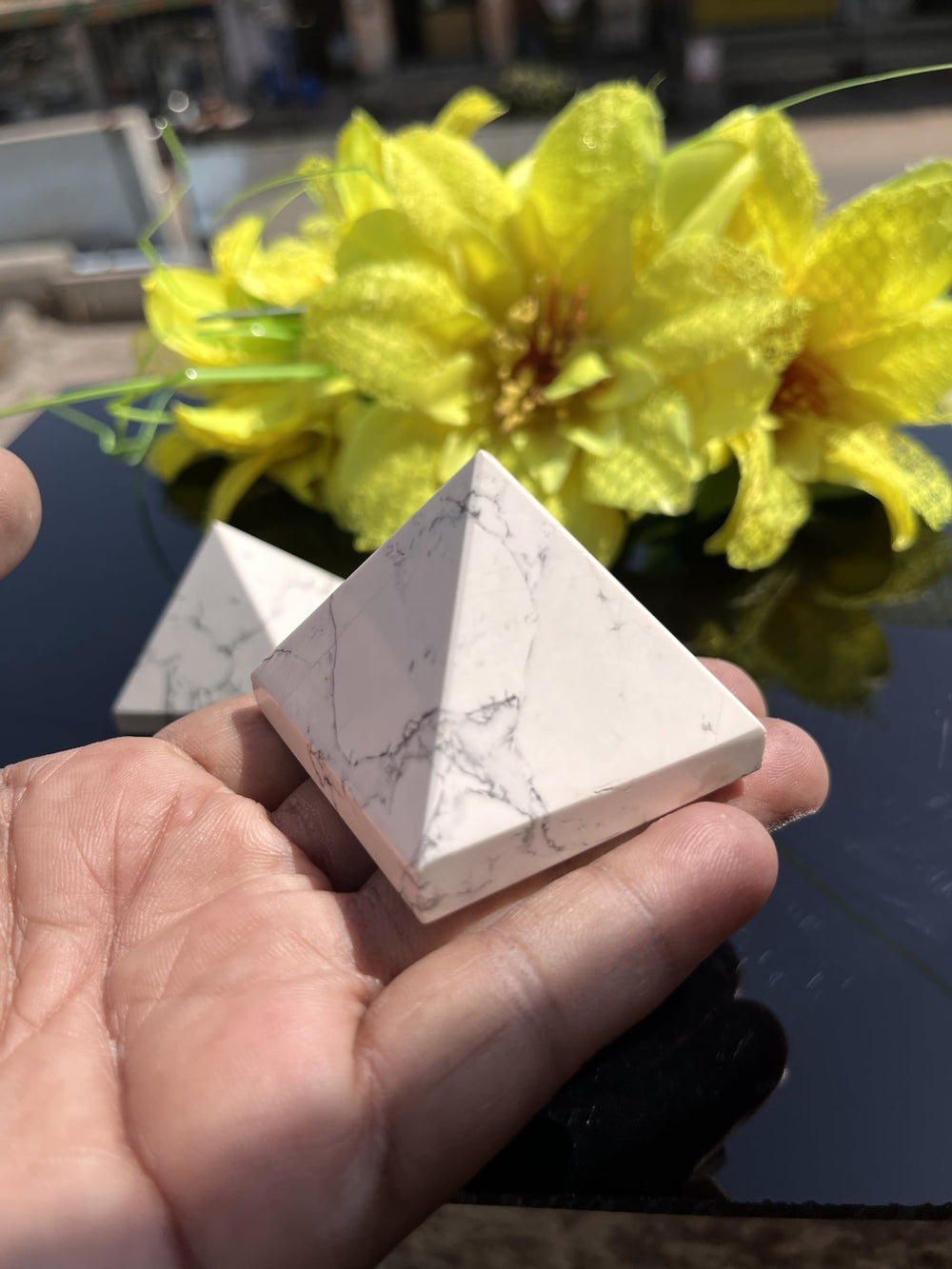 Generic white Howlite pyramid accessory for mindful spaces.