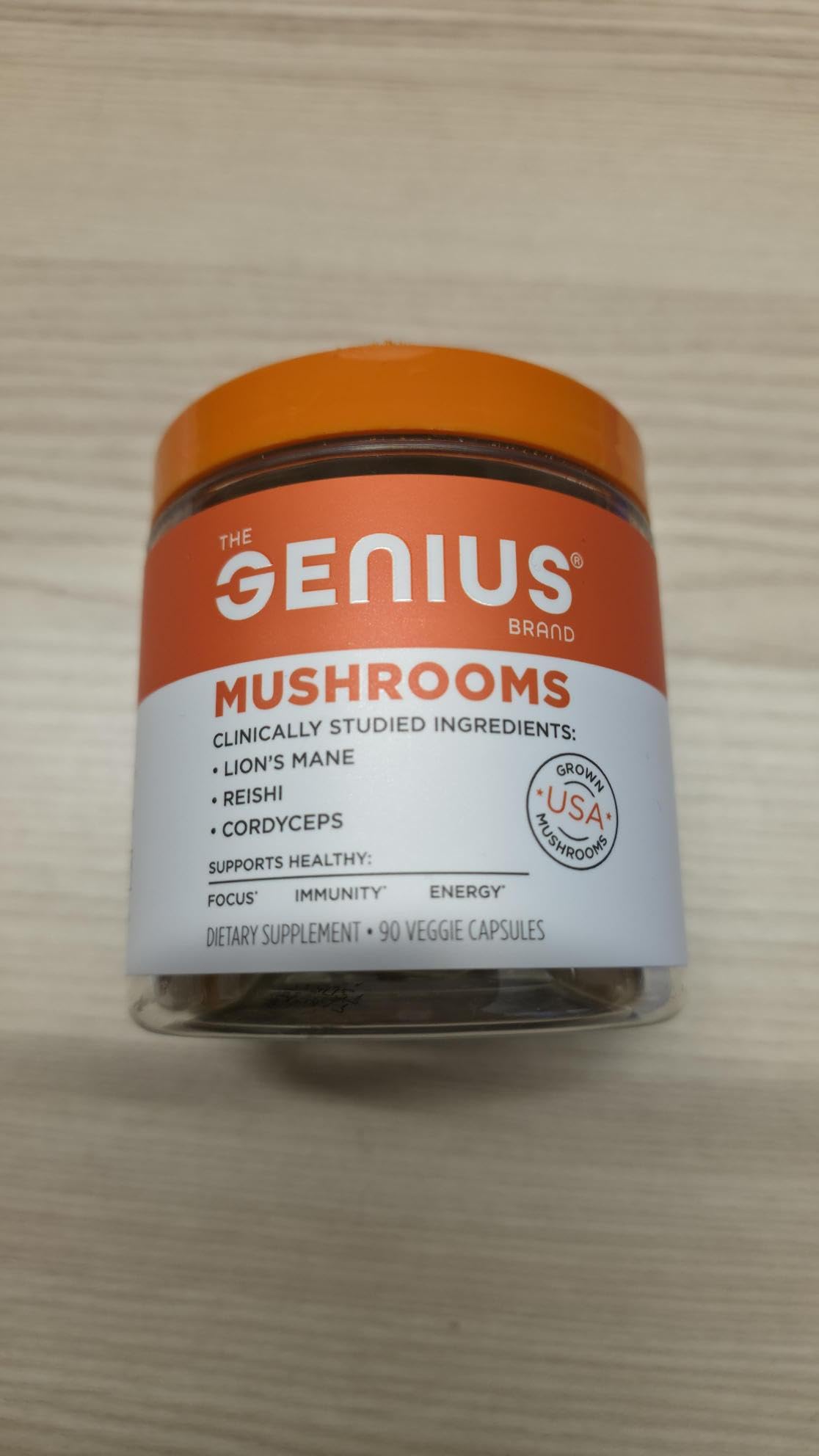 Genius Mushrooms capsules arranged show a compact, travel-friendly daily dose.