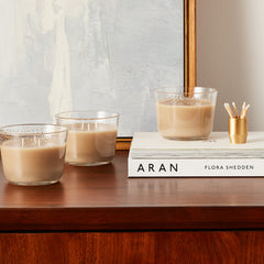 Glade Cashmere Woods ambient glow on a shelf with soft lighting.