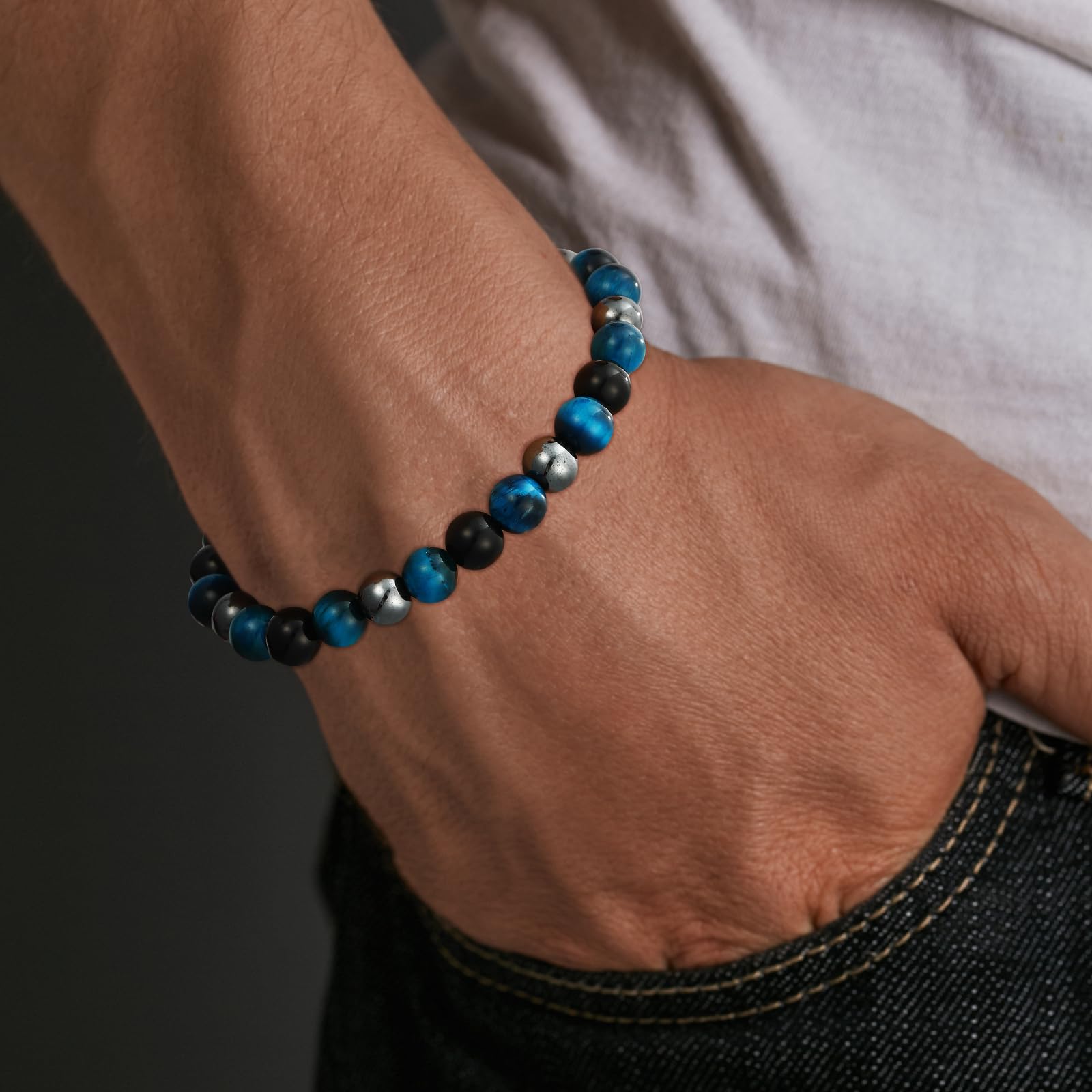 Gnamy triple protection bracelet on wrist, easy elastic fit for most men.