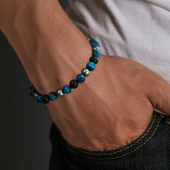 Gnamy triple protection bracelet on wrist, easy elastic fit for most men.