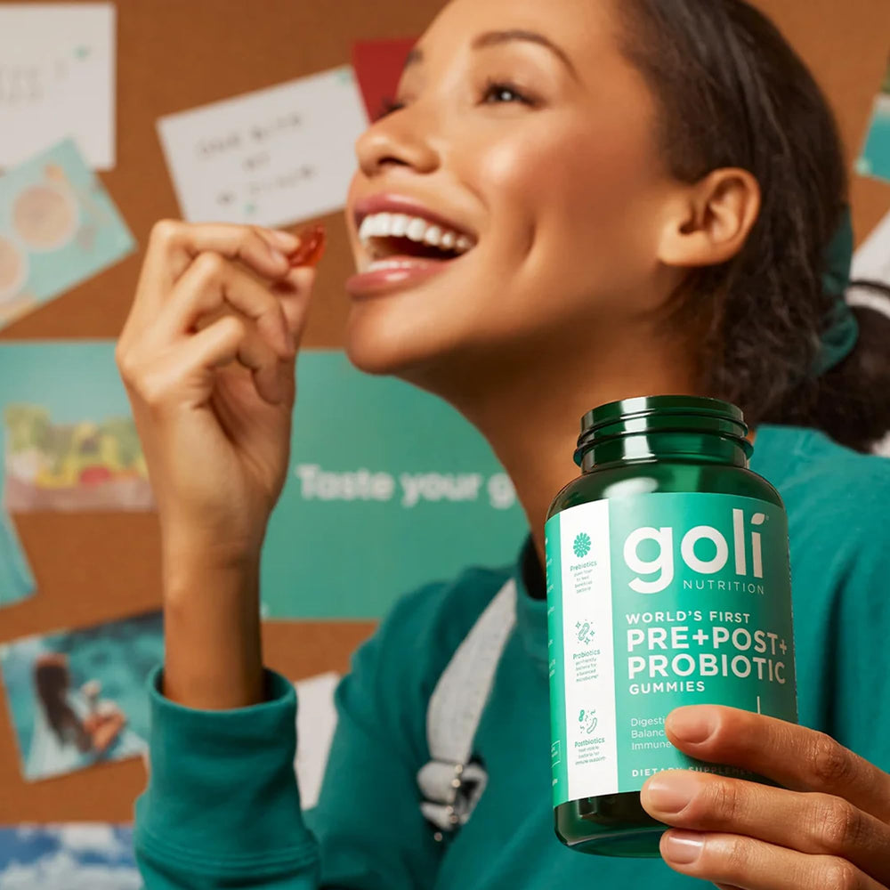 Goli bottle with glass of water for convenient ingestion.