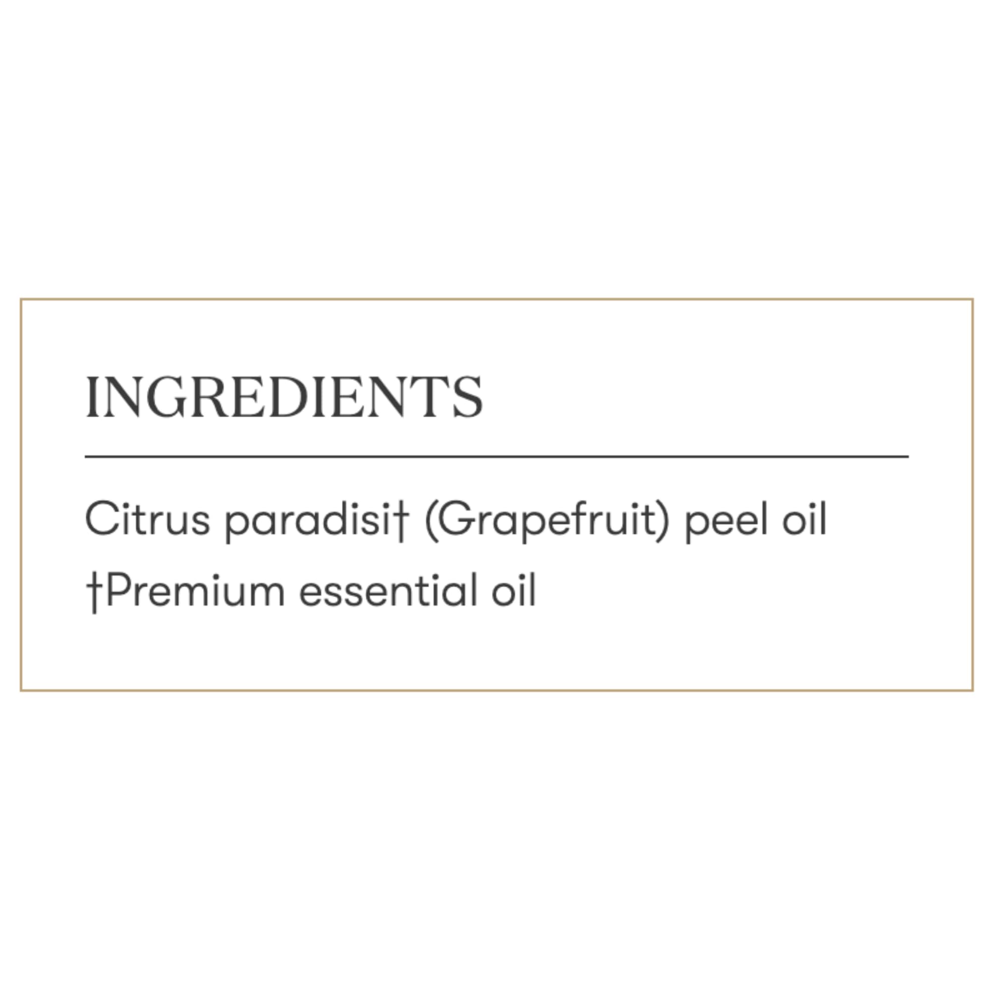Grapefruit essential oil bottle beside a diffuser releasing refreshing scent