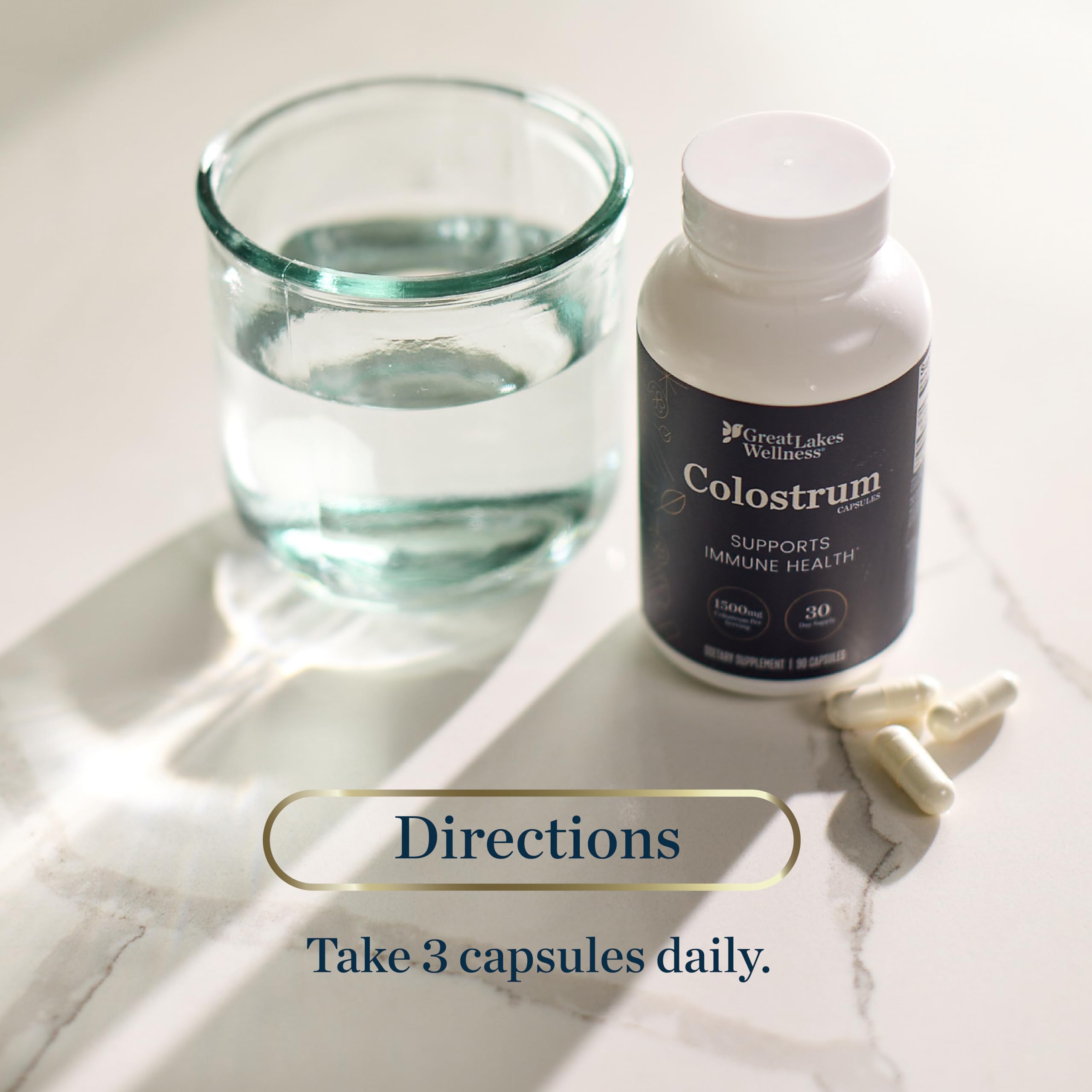 Great Lakes Wellness Colostrum capsules in hand suggesting portable daily immunity support