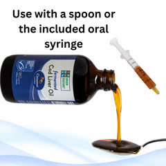 Pouring Green Pasture cod liver oil into a spoon for dosing.