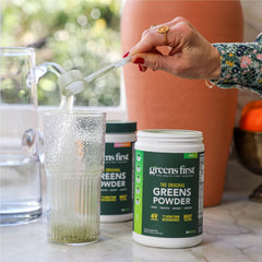 Greens First mixing with water to create a refreshing green drink.