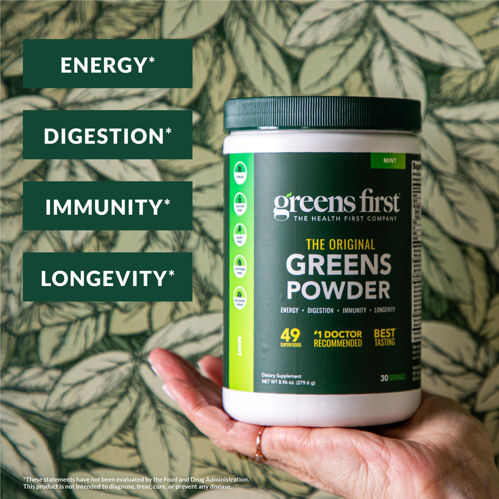 Greens First scoop dissolving in water for a quick nutrient boost.