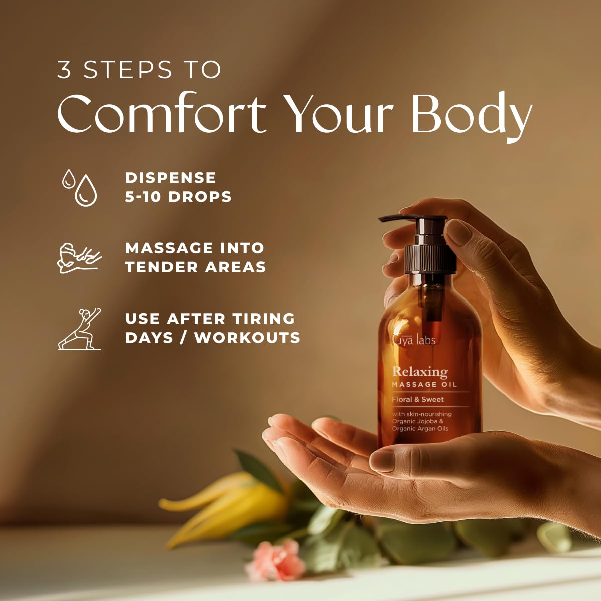 Gya Labs Relaxing Massage Oil with rose geranium and ylang-ylang beside the bottle for floral aroma