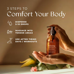 Gya Labs Relaxing Massage Oil with rose geranium and ylang-ylang beside the bottle for floral aroma