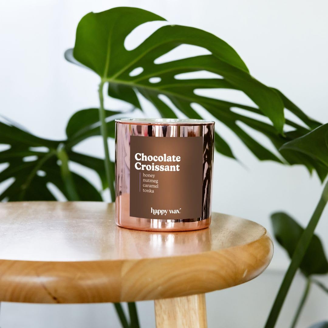 Happy Wax Chocolate Croissant candle with gold-tinged wax creates inviting table centerpiece.