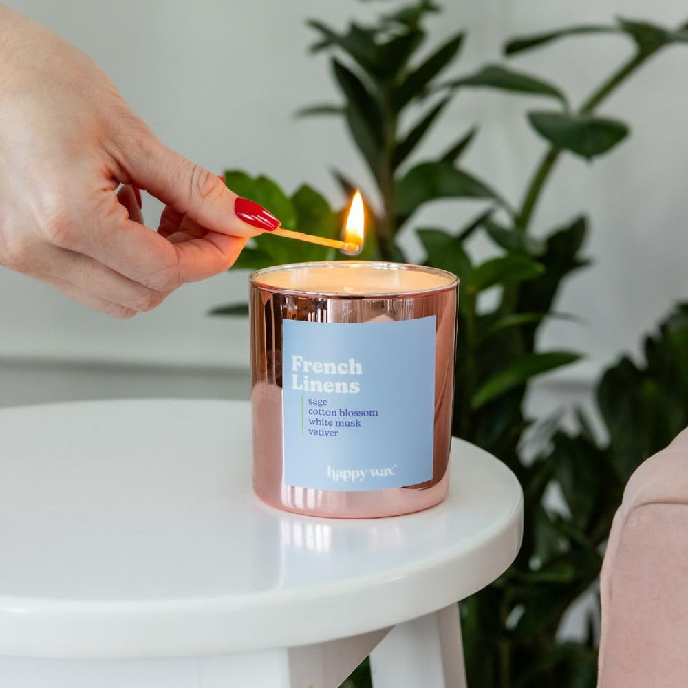 Happy Wax French Linens candle in a bright room for relaxed evenings.