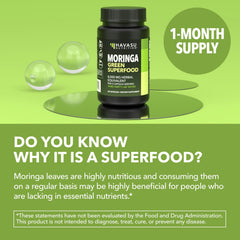 Green superfood capsules sit beside a glass of water.