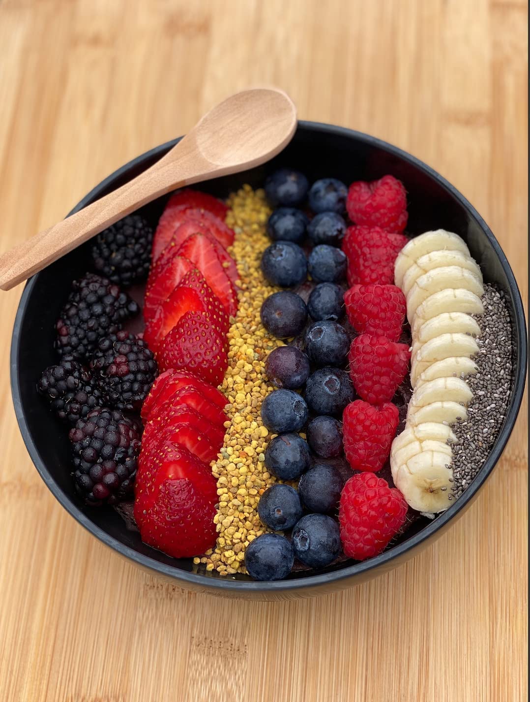 Health and Harmony smoothie bowl topped with bee pollen granules for color and nourishment.